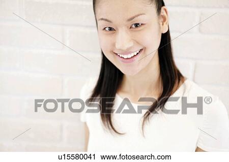Stock Image - Young Woman Looking at Camera. Fotosearch