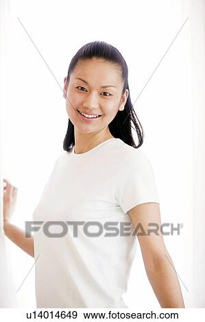 Stock Photo - Young Woman Looking at Camera. Fotosearch