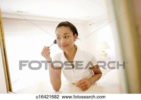 Stock Image - Young Woman Making Up. Fotosearch