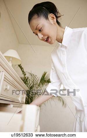 Young Woman Opening Drawer View Large Photo Image Stock Image - Young Woman Opening Drawer. Fotosearch