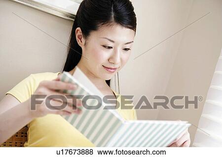 Stock Photo - Young Woman Reading Book. Fotosearch