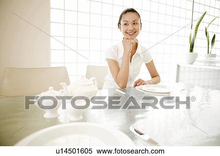 Stock Photography - Young Woman Sitting and Looking Away. Fotosearch