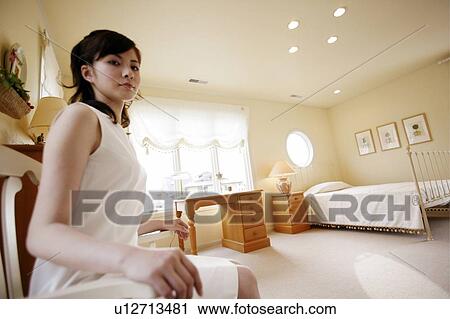 Young Woman Sitting On Chair View Large Photo Image Stock Image - Young Woman Sitting On Chair. Fotosearch
