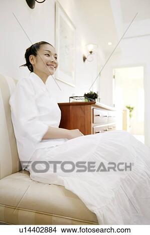 Young Woman Sitting On Sofa View Large Photo Image Picture - Young Woman Sitting On Sofa. Fotosearch