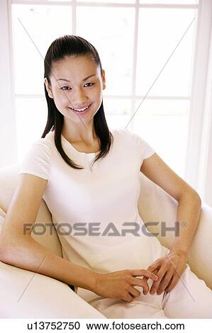 Young Woman Sitting On Sofa View Large Photo Image Stock Image - Young Woman Sitting On Sofa. Fotosearch