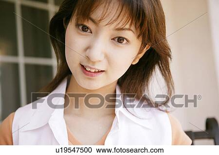 Stock Image - Young Woman Standing. Fotosearch