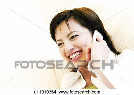 Young Woman Talking On Mobile Phone View Large Photo Image Picture - Young Woman Talking On Mobile Phone. Fotosearch