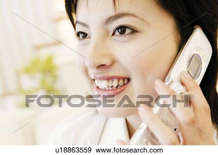 Young Woman Talking On Mobile Phone View Large Photo Image Stock Photo - Young Woman Talking On Mobile Phone. Fotosearch