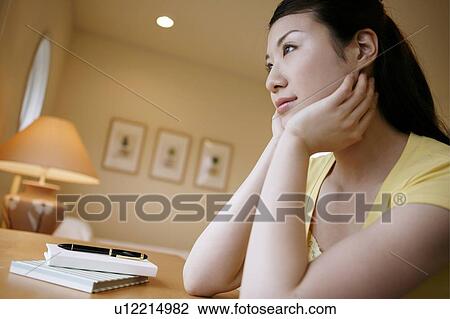 Stock Image - Young Woman Thinking and Looking Away. Fotosearch
