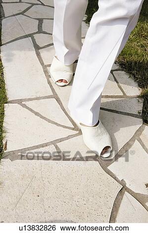 Stock Photograph - Young Woman With Sandals. Fotosearch
