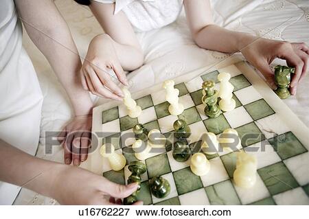 Stock Photo - Young Women Playing Chess. Fotosearch