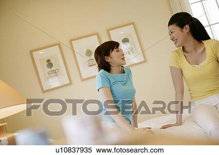 Stock Photography - Young Women Sitting and Talking. Fotosearch