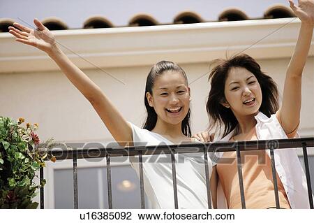 Stock Image - Young Women Waving. Fotosearch