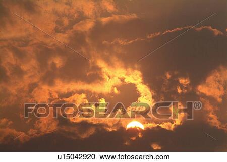 Stock Image - Sky in sunset color, low angle view. Fotosearch
