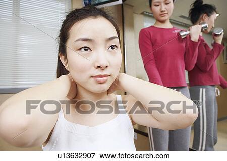 Close-up of a young woman exercising View Large Photo Image Stock Photo - Close-up of a young woman exercising. Fotosearch