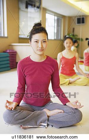 Close-up of a young woman sitting in the lotus position View Large Photo Image Stock Image - Close-up of a young woman sitting in the lotus position. Fotosearch