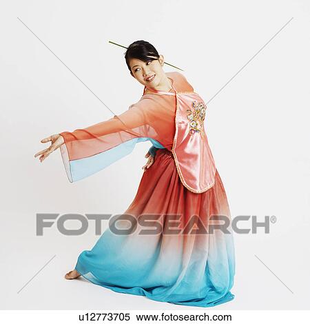 Close-up of a young woman wearing traditional clothing and dancing View Large Photo Image Stock Photography - Close-up of a young woman wearing traditional clothing and dancing. Fotosearch