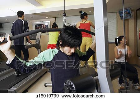 Stock Photo - Five people exercising in a gym. Fotosearch