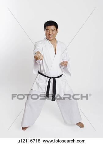 Portrait of a mid adult man practicing martial arts View Large Photo Image Stock Photo - Portrait of a mid adult man practicing martial arts. Fotosearch