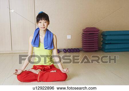Stock Photograph - Portrait of a young woman meditating. Fotosearch
