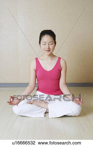Stock Image - Teenage girl meditating. Fotosearch