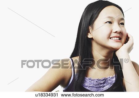Close-up of a teenage girl with her hand under her chin View Large Photo Image Stock Image - Close-up of a teenage girl with her hand under her chin. Fotosearch