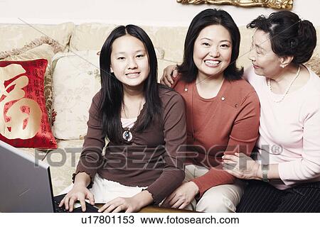 Stock Image - Portrait of a girl sitting with her mother and her grandmother. Fotosearch