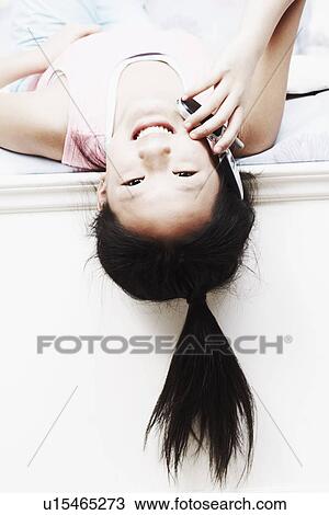Stock Image - Portrait of a girl talking on a mobile phone. Fotosearch