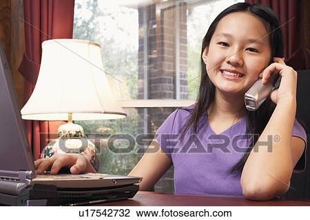 Portrait of a girl talking on a cordless telephone View Large Photo Image Stock Image - Portrait of a girl talking on a cordless telephone. Fotosearch