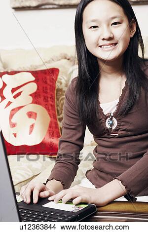Portrait of a girl using a laptop View Large Photo Image Picture - Portrait of a girl using a laptop. Fotosearch