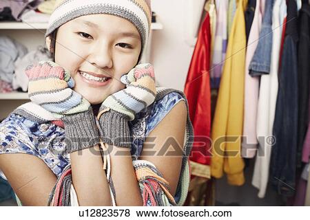 Stock Photo - Portrait of a girl wearing a hat and gloves. Fotosearch
