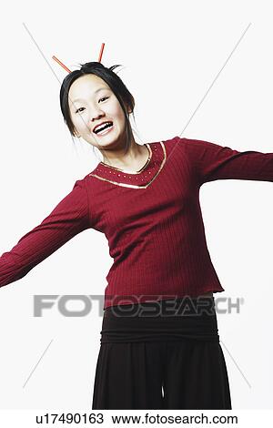 Portrait of a teenage girl standing with her arms outstretched View Large Photo Image Stock Image - Portrait of a teenage girl standing with her arms outstretched. Fotosearch