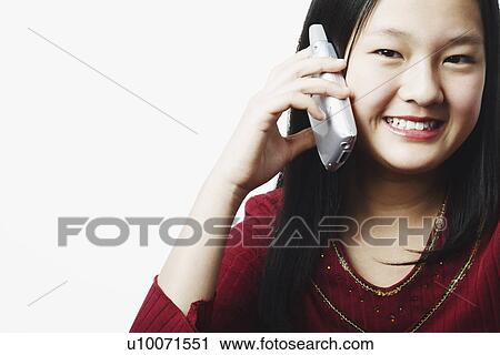 Portrait of a teenage girl talking on a mobile phone View Large Photo Image Stock Image - Portrait of a teenage girl talking on a mobile phone. Fotosearch