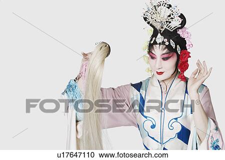 Stock Image - Close-up of a mature woman wearing traditional clothing. Fotosearch