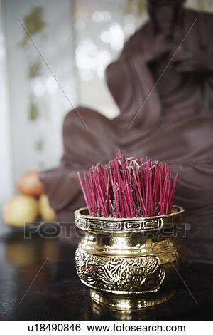 Stock Photograph - Close-up of incense sticks in a jar. Fotosearch