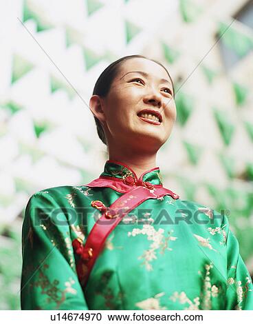 Low angle view of a young woman in a traditional dress View Large Photo Image Stock Image - Low angle view of a young woman in a traditional dress. Fotosearch
