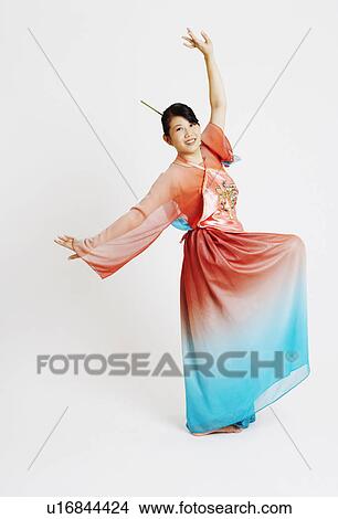 Portrait of a young woman wearing traditional clothing and dancing View Large Photo Image Picture - Portrait of a young woman wearing traditional clothing and dancing. Fotosearch
