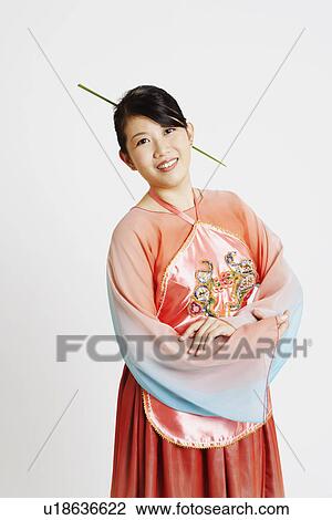 Stock Image - Portrait of a young woman wearing traditional clothing and smiling. Fotosearch