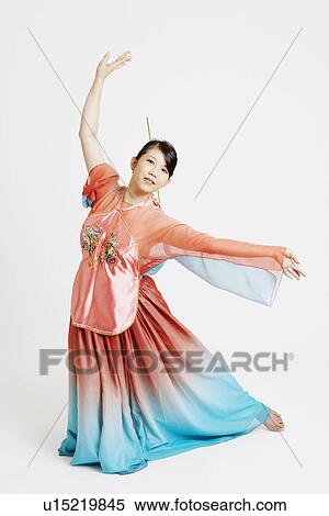 Portrait of a young woman wearing traditional clothing and dancing View Large Photo Image Stock Photography - Portrait of a young woman wearing traditional clothing and dancing. Fotosearch