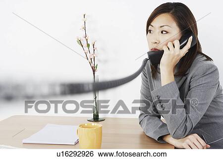 Stock Photograph - Close-up of a businesswoman talking on the telephone. Fotosearch