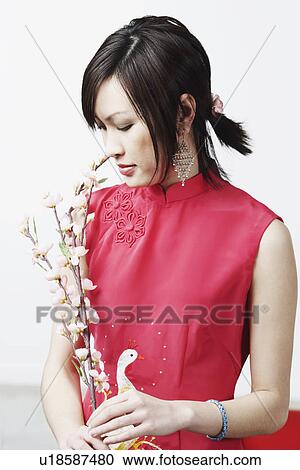 Close-up of a young woman holding flowers View Large Photo Image Stock Image - Close-up of a young woman holding flowers. Fotosearch