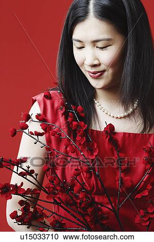 Stock Image - Close-up of a young woman looking down. Fotosearch