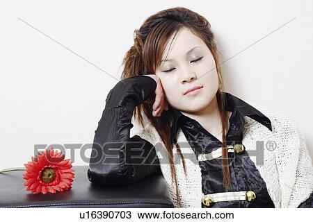 Stock Image - Close-up of a young woman sleeping. Fotosearch