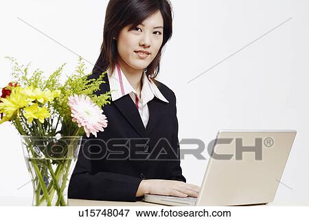 Portrait of a businesswoman using a laptop View Large Photo Image Stock Photo - Portrait of a businesswoman using a laptop. Fotosearch