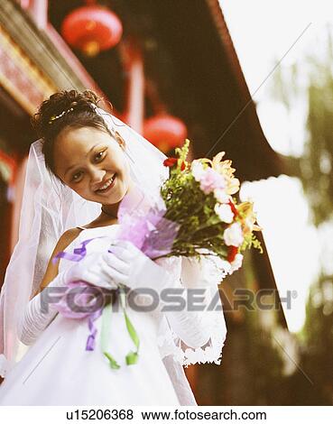 Stock Photo - Portrait of a young woman in the wedding dress. Fotosearch
