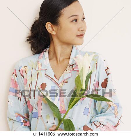 Stock Photography - Young woman holding a flower. Fotosearch
