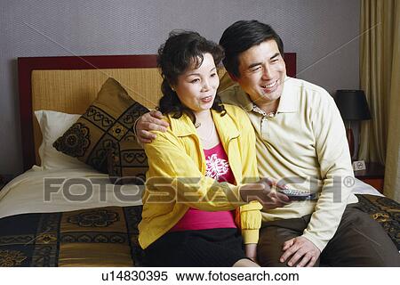 Mature woman sitting with a mature woman pointing a remote control View Large Photo Image Stock Photography - Mature woman sitting with a mature woman pointing a remote control. Fotosearch