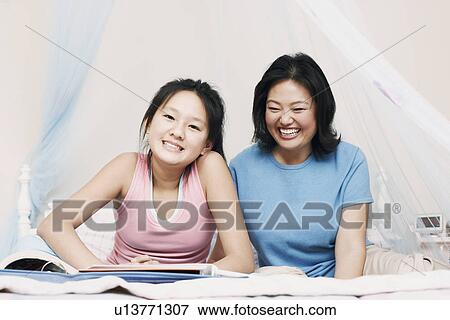 Mother and her daughter smiling View Large Photo Image Stock Photo - Mother and her daughter smiling. Fotosearch