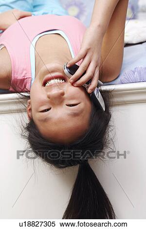 Portrait of a girl talking on a mobile phone View Large Photo Image Stock Photography - Portrait of a girl talking on a mobile phone. Fotosearch