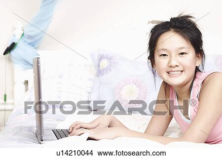 Portrait of a girl using a laptop View Large Photo Image Picture - Portrait of a girl using a laptop. Fotosearch